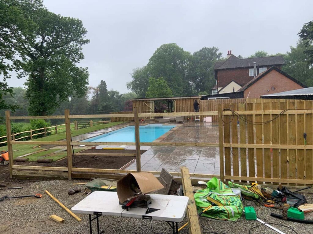 This is a photo of Bespoke custom fencing installed around a swimming pool by Fast Fix Fencing Doddington