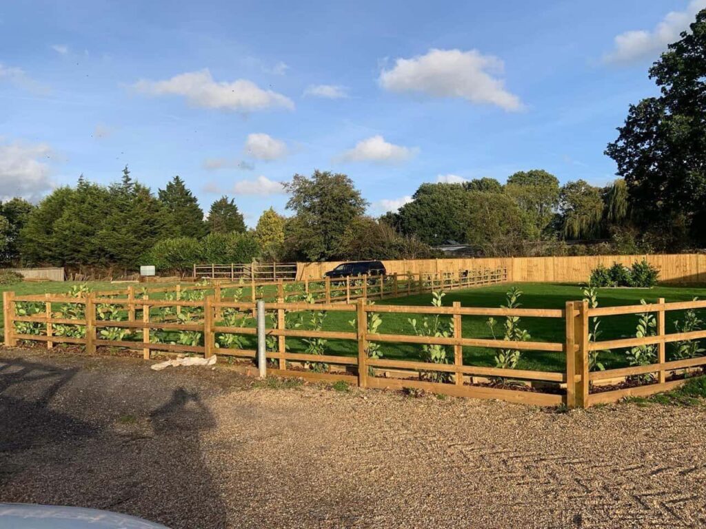 This is a photo of post and rail fencing with a gravel board installed at the base to create a flower bed, and at the rear is feather edge fencing along the edge of the garden. All works carried out by Fast Fix Fencing Doddington